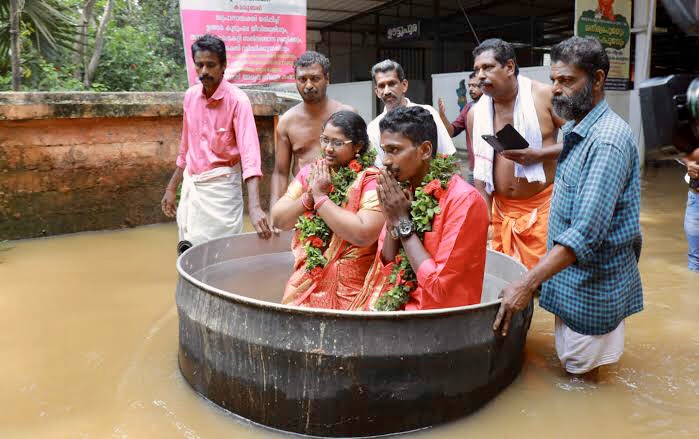 COUPLE SAILS TO WEDDING IN COOKING POT AMID FLOODS