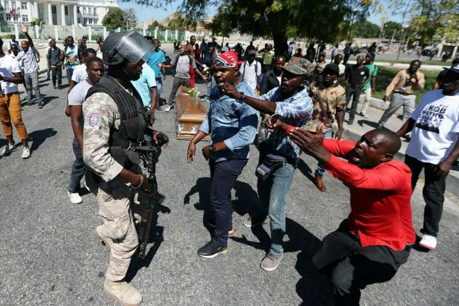 HAITIAN POLICE OFFICERS KILLED DURING TENSE PROTESTS